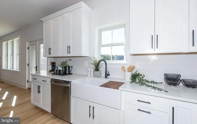 a kitchen with sink stove and wooden floor
