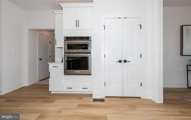 a dining room with furniture and wooden floor