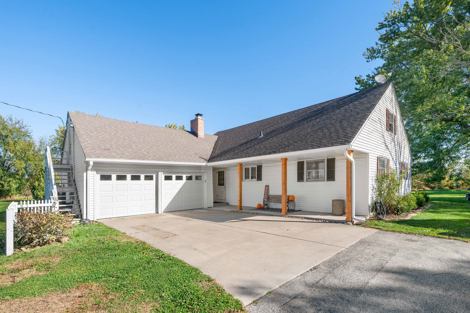 10266 Pritchard Road Hinckley, IL 60520 - Photo 1 of 41 a front view of a house with a yard and potted plants