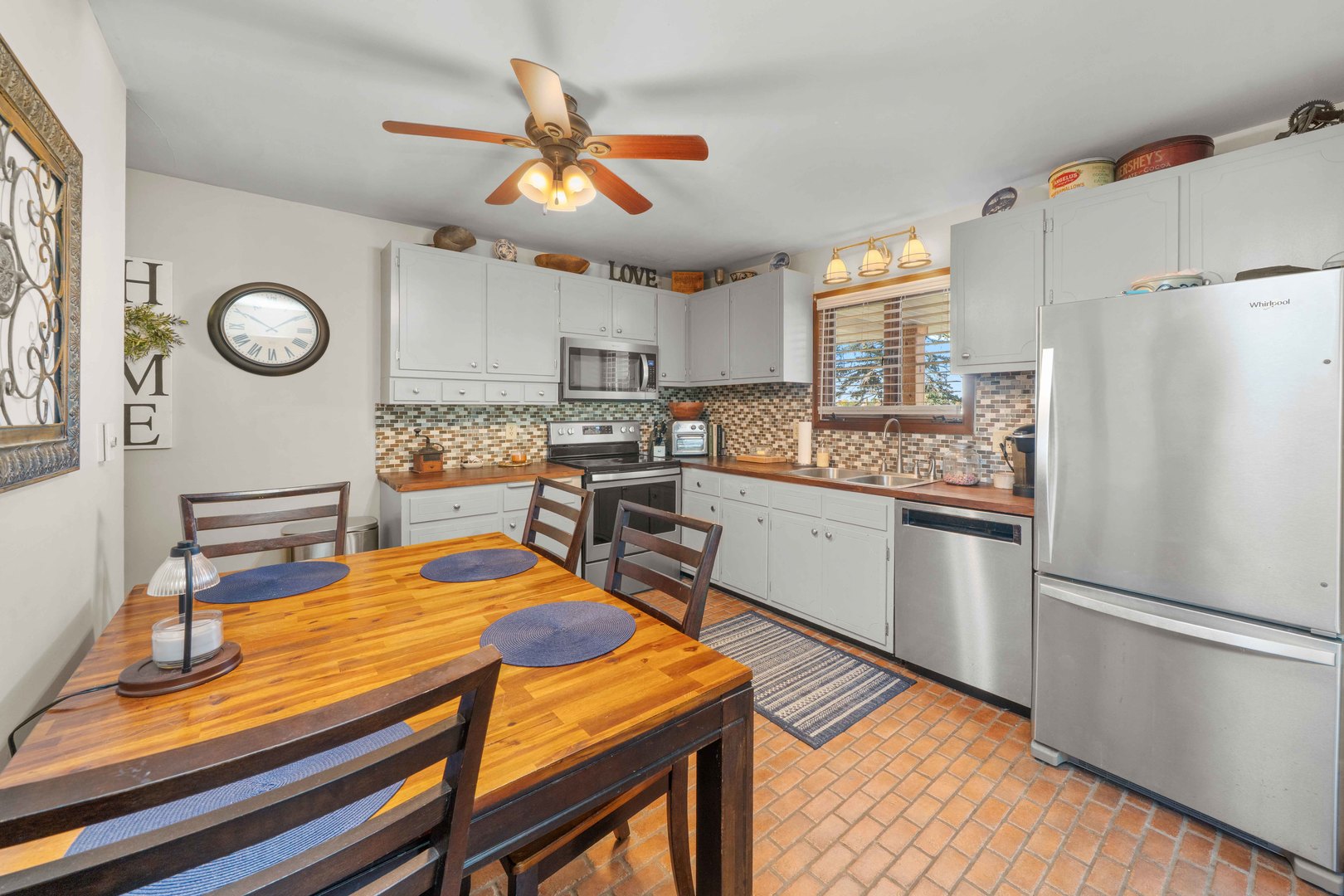 10266 Pritchard Road Hinckley, IL 60520 - Photo 10 of 41 a kitchen with a refrigerator a stove cabinets and wooden floor