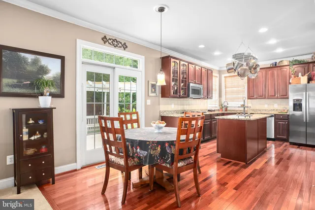 a living room with furniture a fireplace and a large window