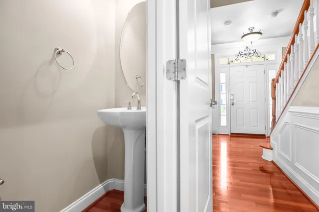 a spacious bedroom with wooden floor and window