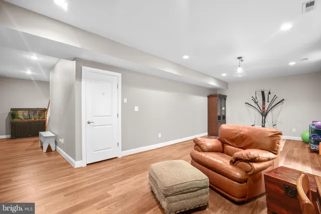a living room with furniture gym equipment and a flat screen tv