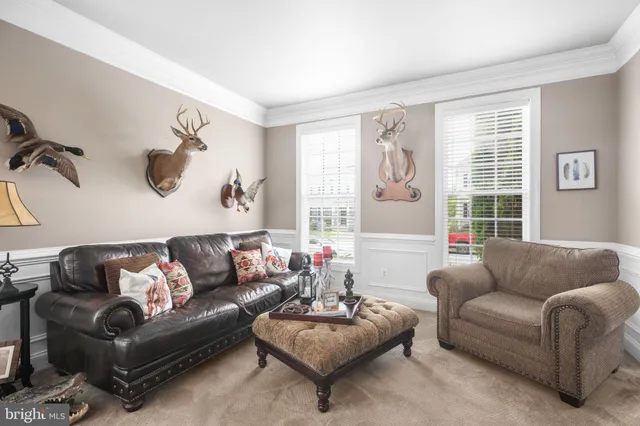 a kitchen with stainless steel appliances granite countertop wooden cabinets a dining table and chairs