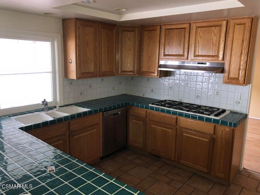 3050 Cicero Court Simi Valley, CA 93063 - Photo 3 of 11 a kitchen with stainless steel appliances granite countertop a sink stove and cabinets