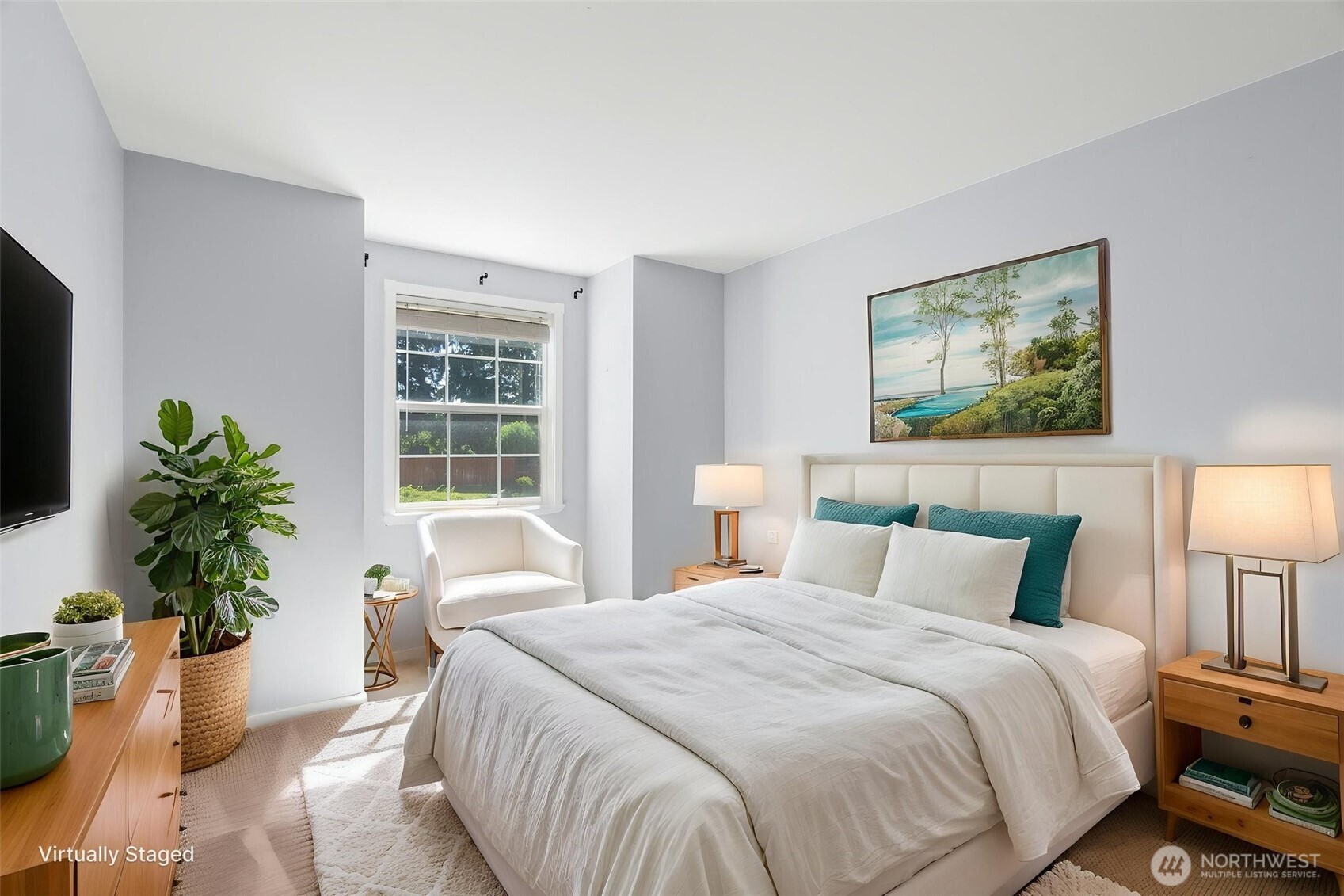 26227 Montera Loop Northeast Kingston, WA 98346 - Photo 14 of 22 a bedroom with a large bed and a potted plant