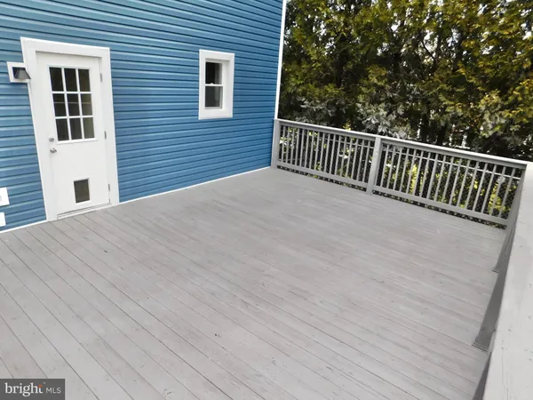 a view of a yard with wooden fence