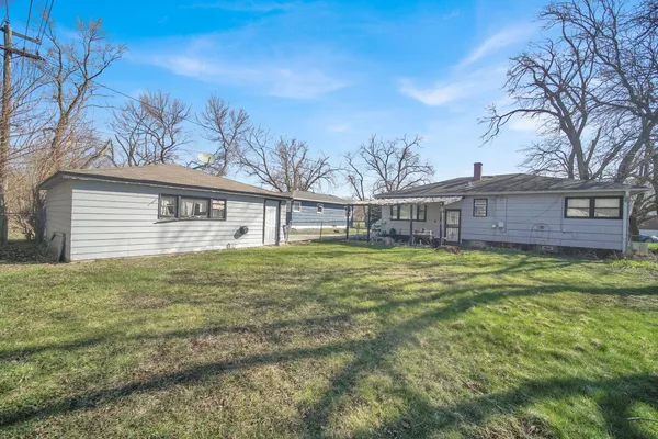 a view of a house with a backyard