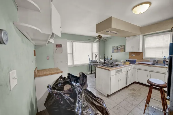 a kitchen with a sink appliances and cabinets