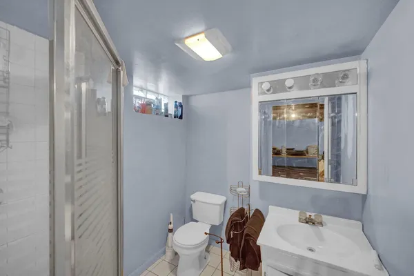 a bathroom with a toilet a sink and a mirror