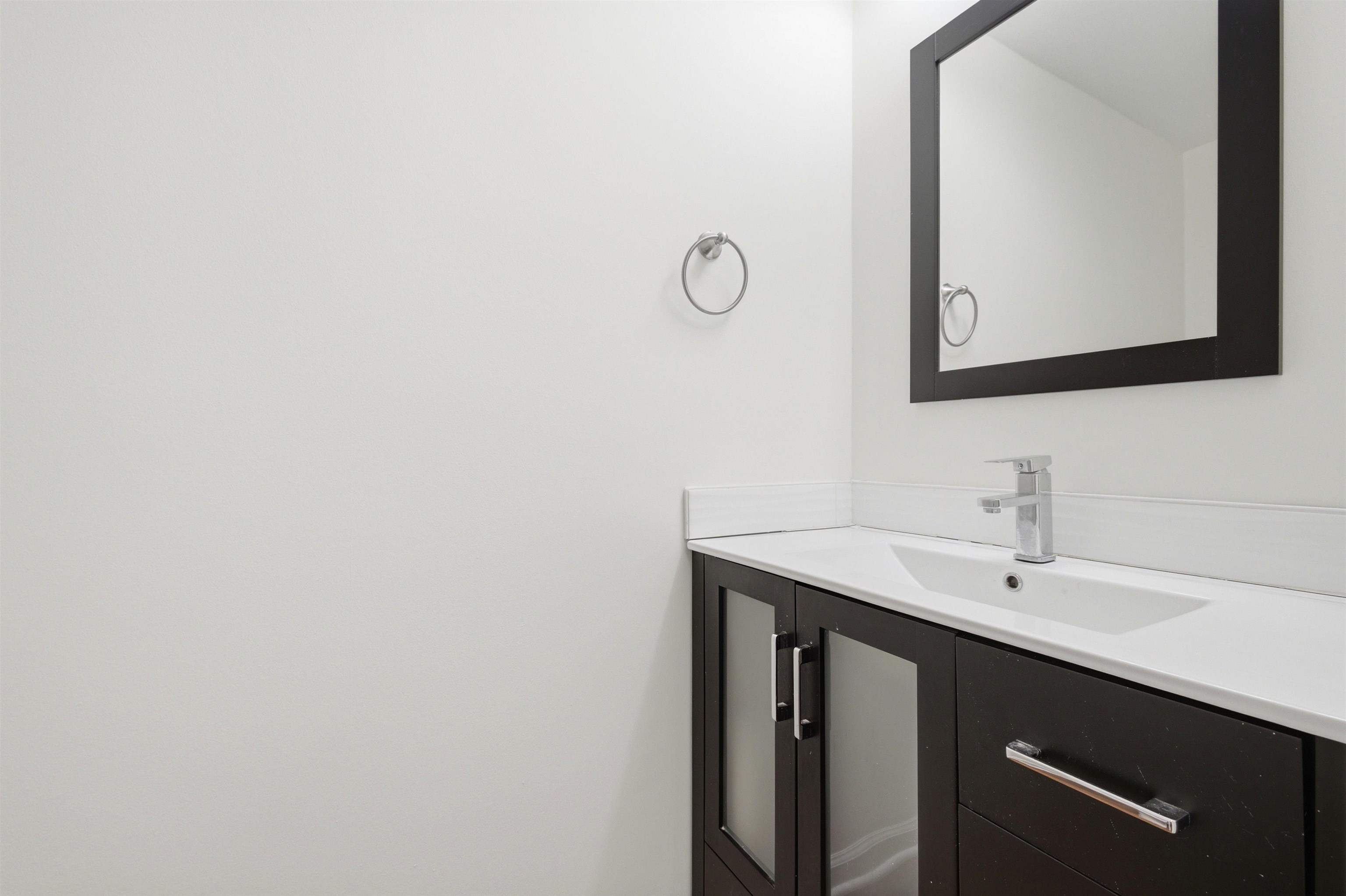 96 Berryfield Cove Collierville, TN 38017 - Photo 18 of 39 Dark wood-finish vanity with a white countertop and integrated sink