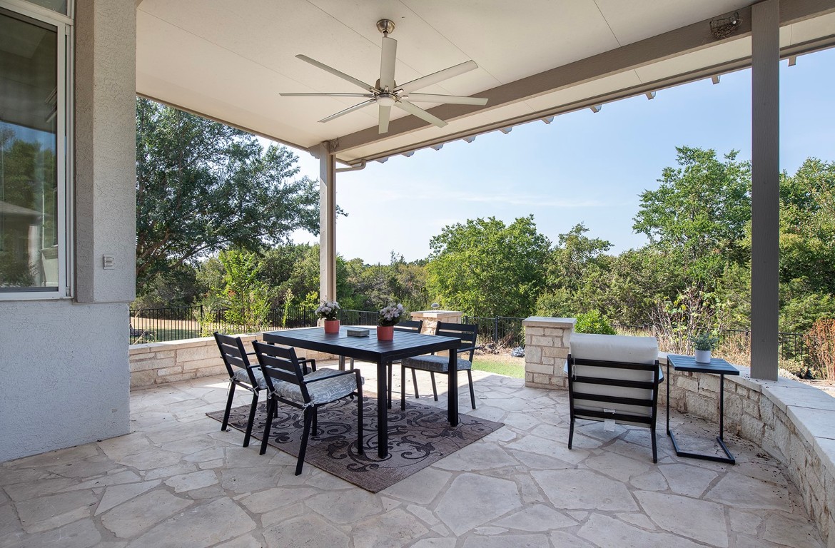a view of a patio with dining table and chairs