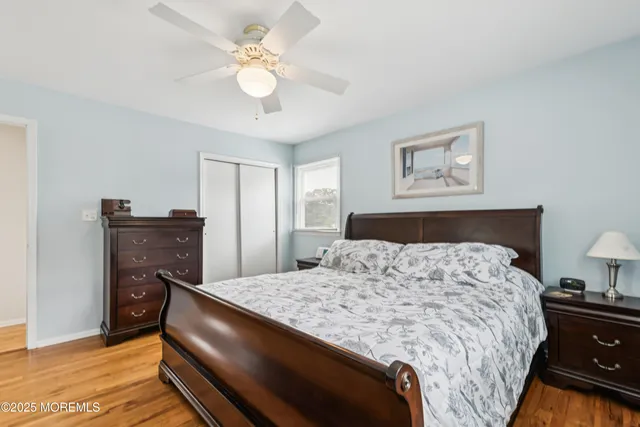 a bedroom with a bed and dresser with lamp
