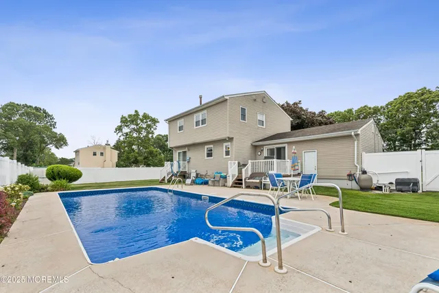 a front view of house with outdoor seating yard and barbeque oven