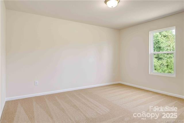 9740 Weikert Road Charlotte, NC 28215 - Photo 13 of 16 an empty room with a window