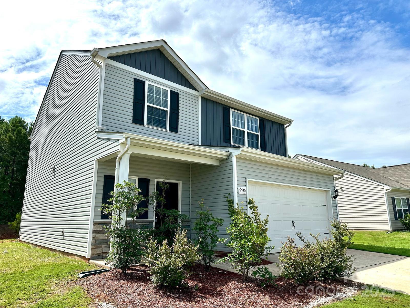 9740 Weikert Road Charlotte, NC 28215 - Photo 3 of 16 a front view of a house with garden
