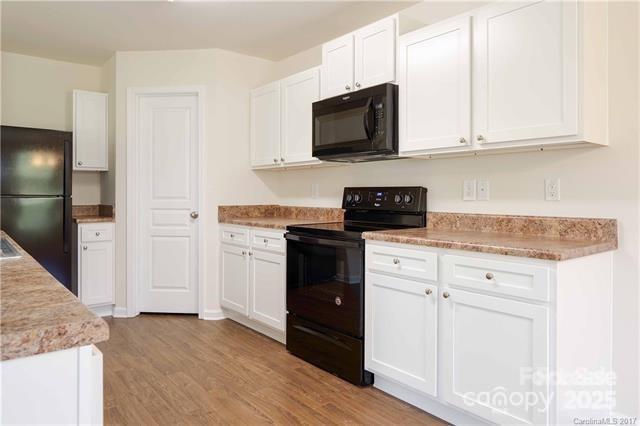 9740 Weikert Road Charlotte, NC 28215 - Photo 5 of 16 a kitchen with granite countertop white cabinets and stainless steel appliances