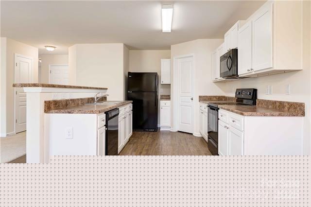9740 Weikert Road Charlotte, NC 28215 - Photo 6 of 16 a kitchen with stainless steel appliances kitchen island granite countertop a stove top oven a sink a refrigerator and white cabinets