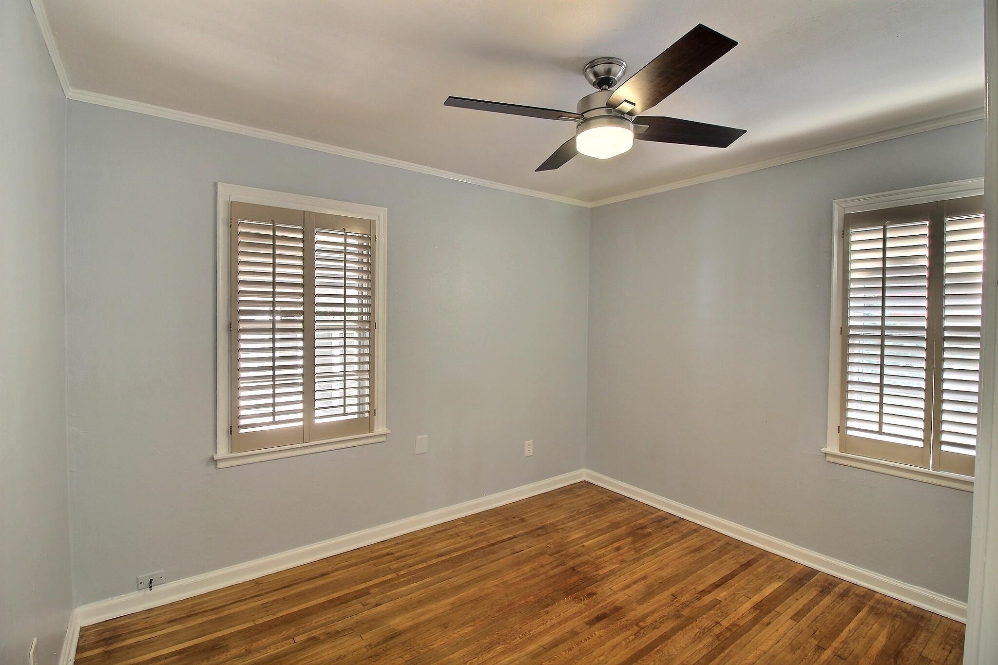 4528 Quince Road Memphis, TN 38117 - Photo 11 of 27 a view of empty room with wooden floor and fan