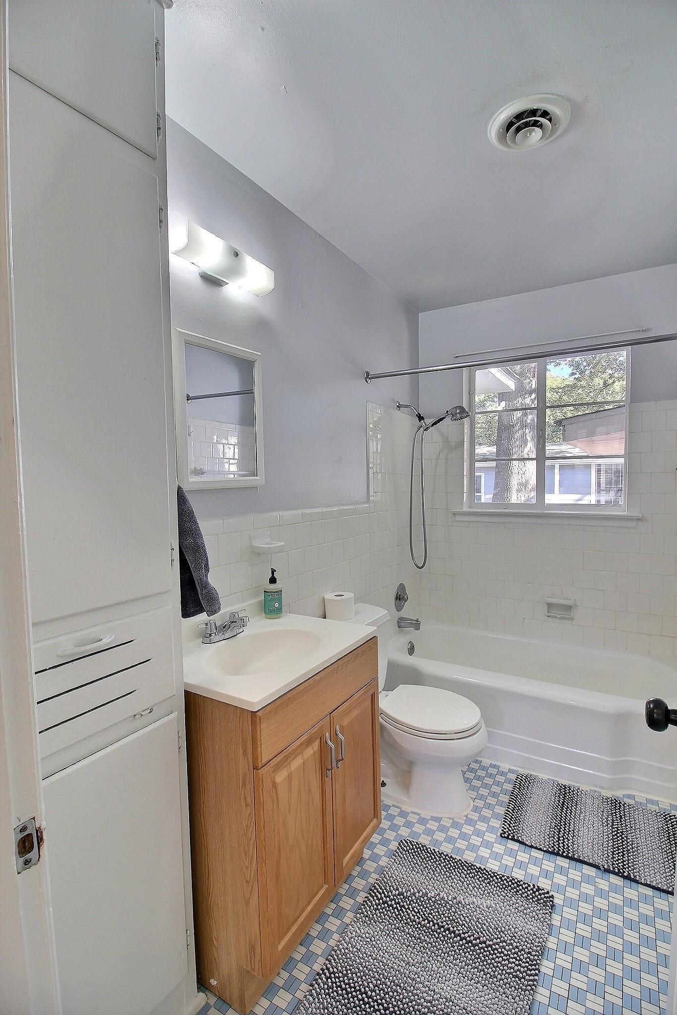 4528 Quince Road Memphis, TN 38117 - Photo 12 of 27 a bathroom with a toilet sink and mirror