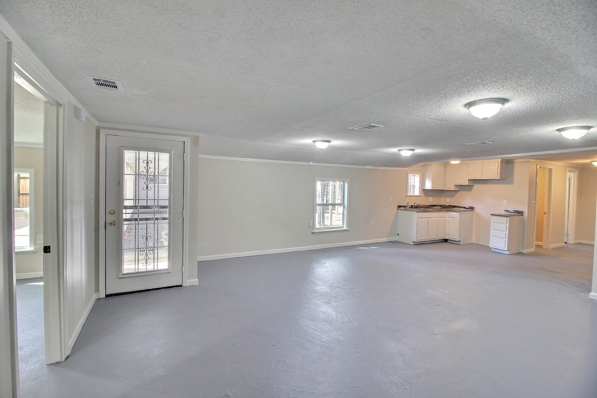 4528 Quince Road Memphis, TN 38117 - Photo 17 of 27 a view of an empty room with a window and wooden floor