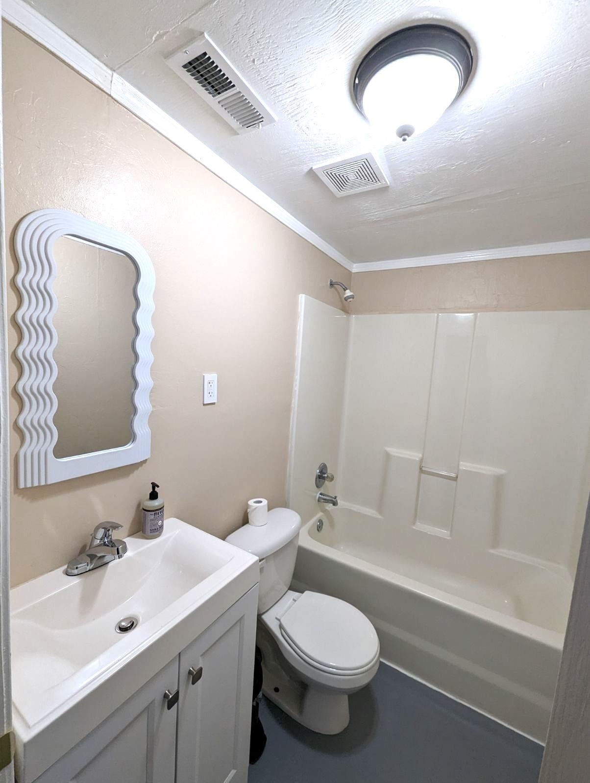 4528 Quince Road Memphis, TN 38117 - Photo 20 of 27 a bathroom with a toilet sink and mirror
