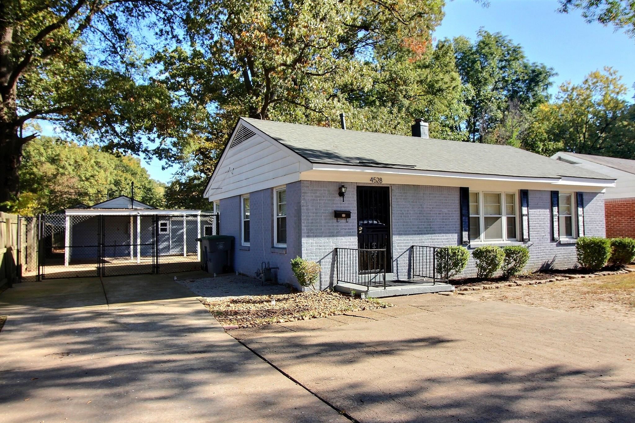 4528 Quince Road Memphis, TN 38117 - Photo 2 of 27 a front view of a house with a tree in front