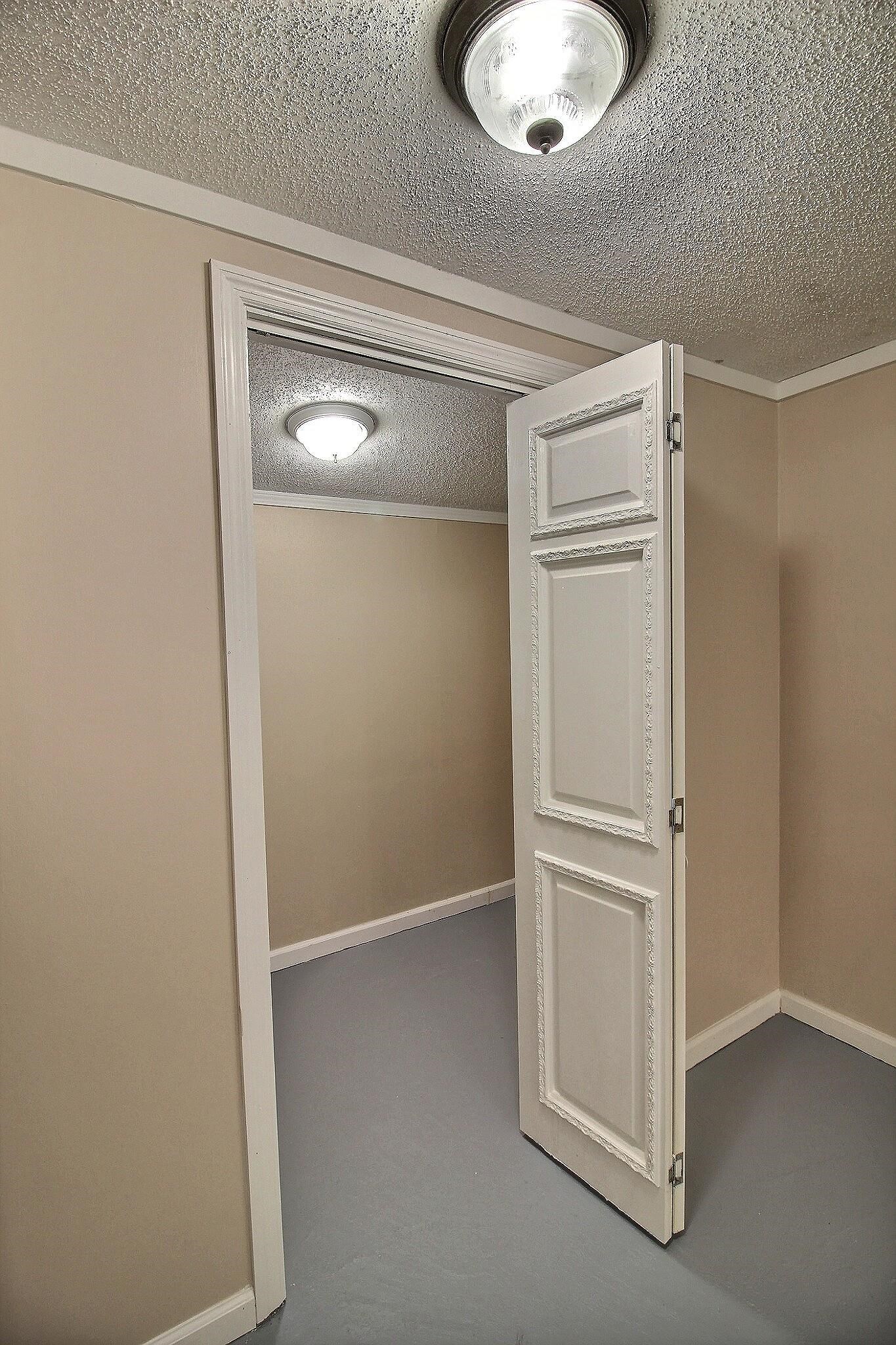 4528 Quince Road Memphis, TN 38117 - Photo 25 of 27 an empty room with wooden floor and closet