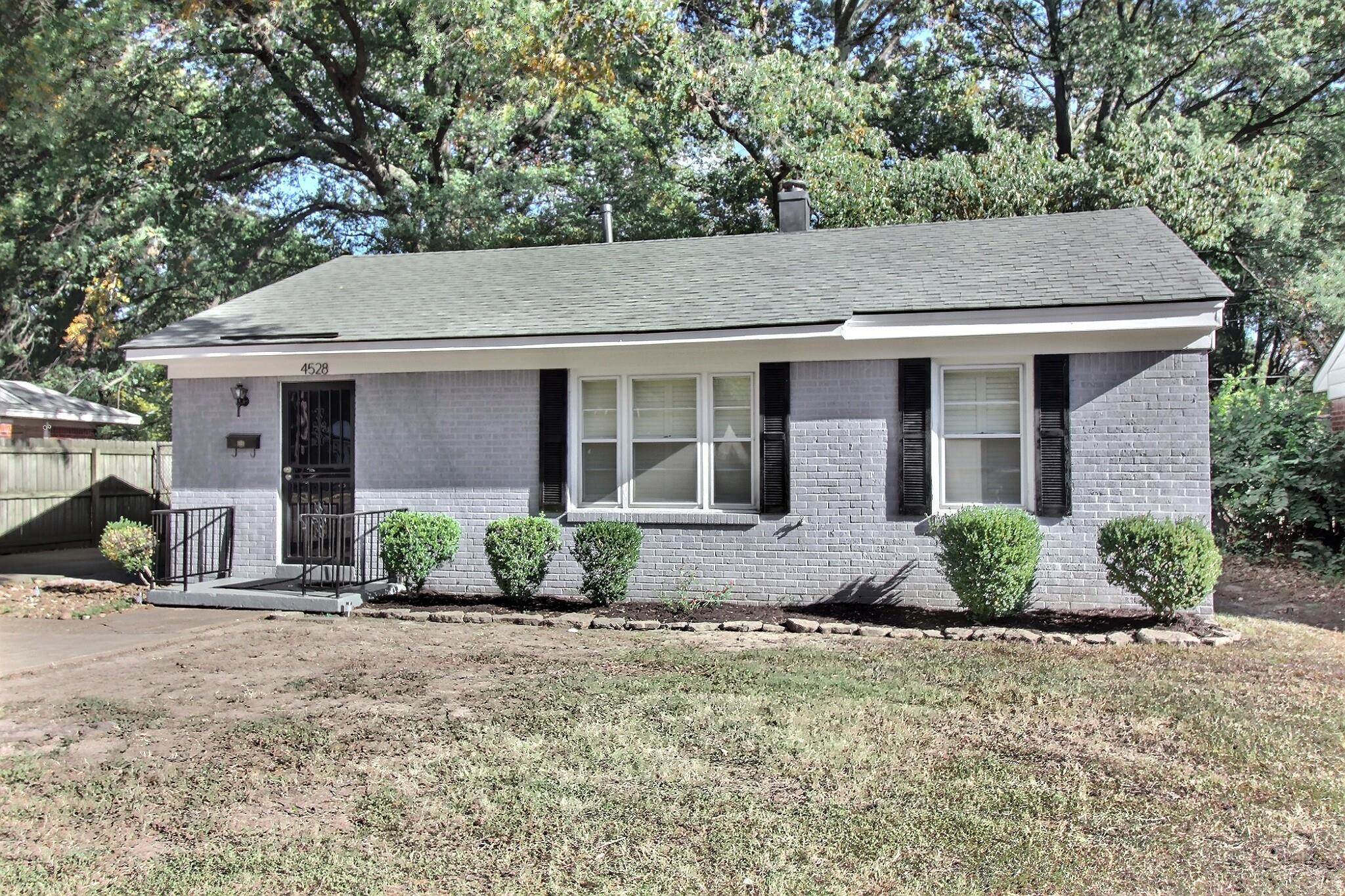 4528 Quince Road Memphis, TN 38117 - Photo 3 of 27 a front view of a house with garden