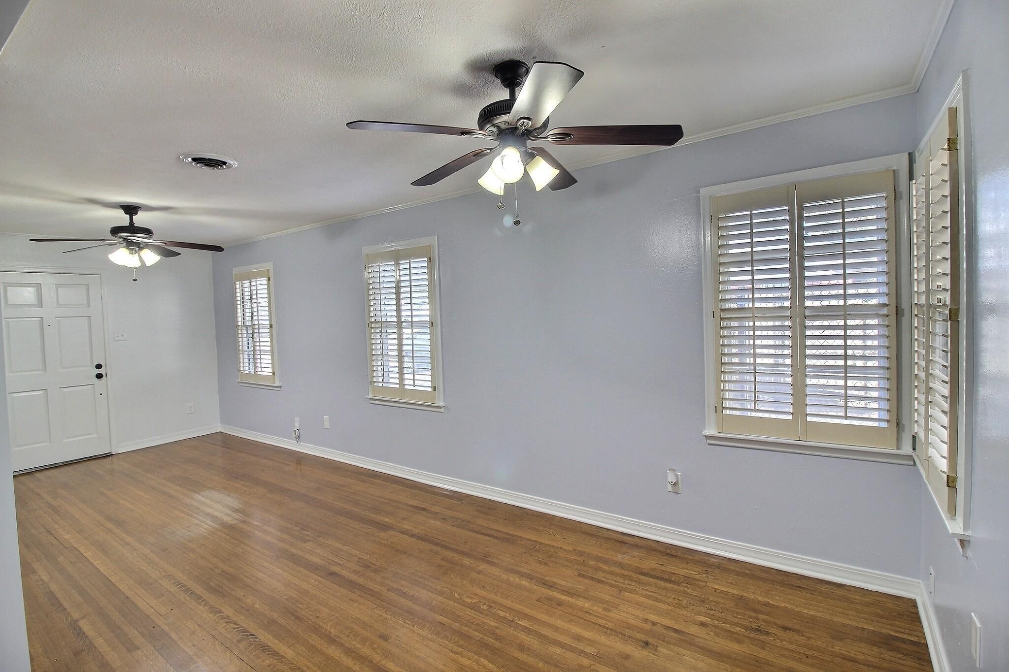 4528 Quince Road Memphis, TN 38117 - Photo 4 of 27 a view of an empty room with a window and wooden floor