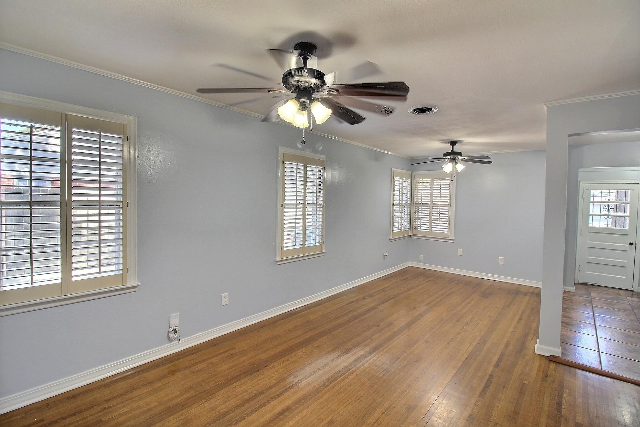 4528 Quince Road Memphis, TN 38117 - Photo 5 of 27 a view of empty room with wooden floor and fan
