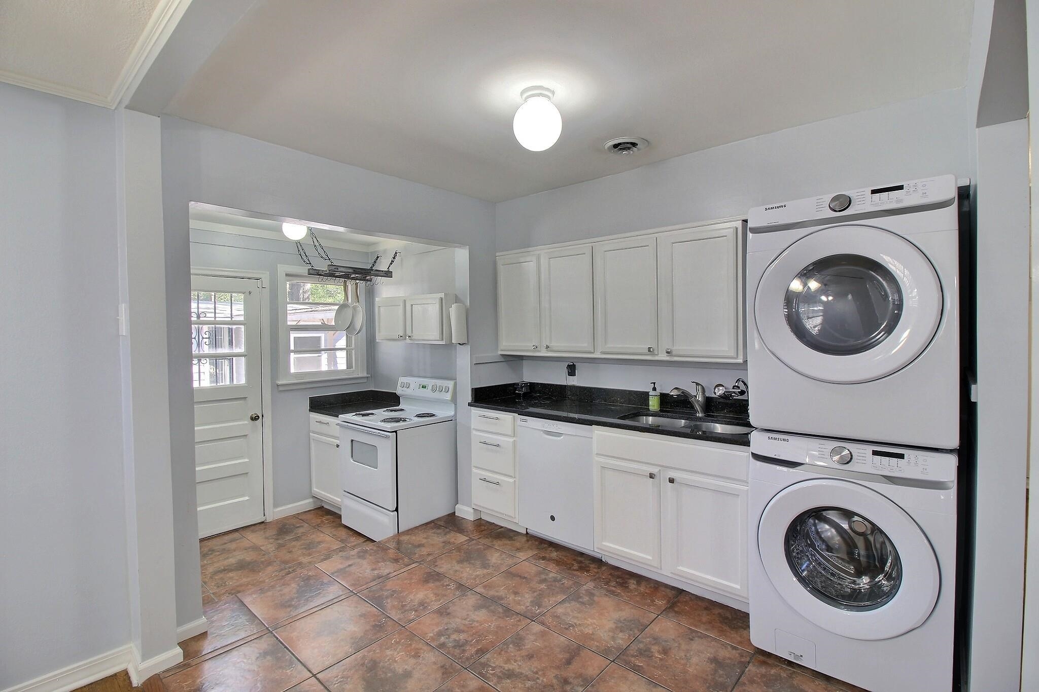 4528 Quince Road Memphis, TN 38117 - Photo 6 of 27 a kitchen with white cabinets and white appliances