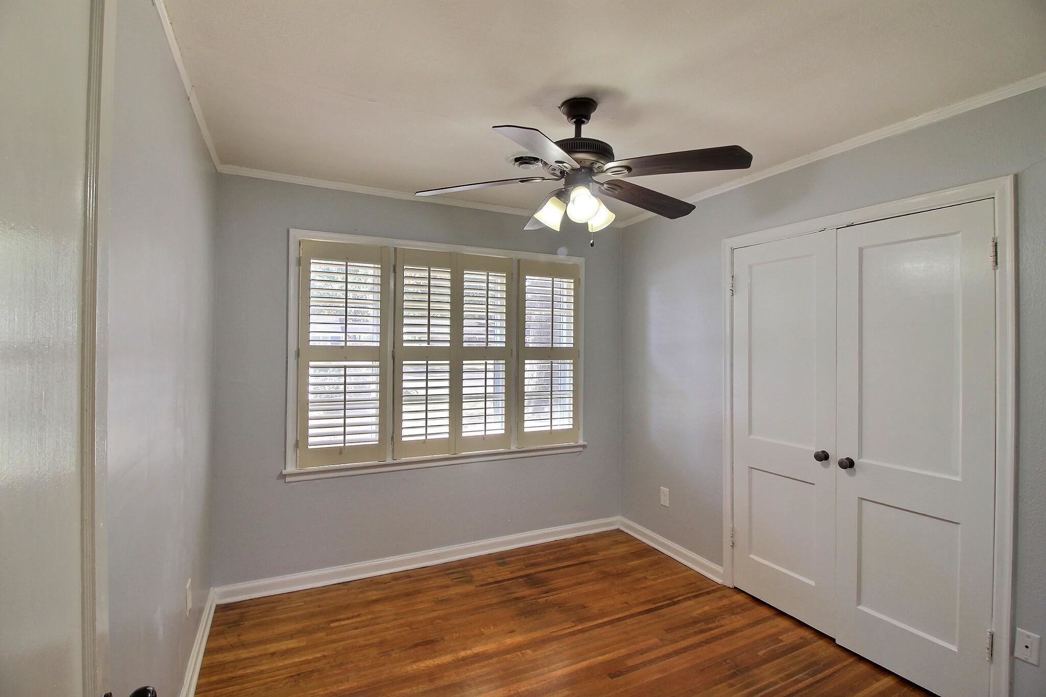 4528 Quince Road Memphis, TN 38117 - Photo 9 of 27 a view of an empty room with window and wooden floor