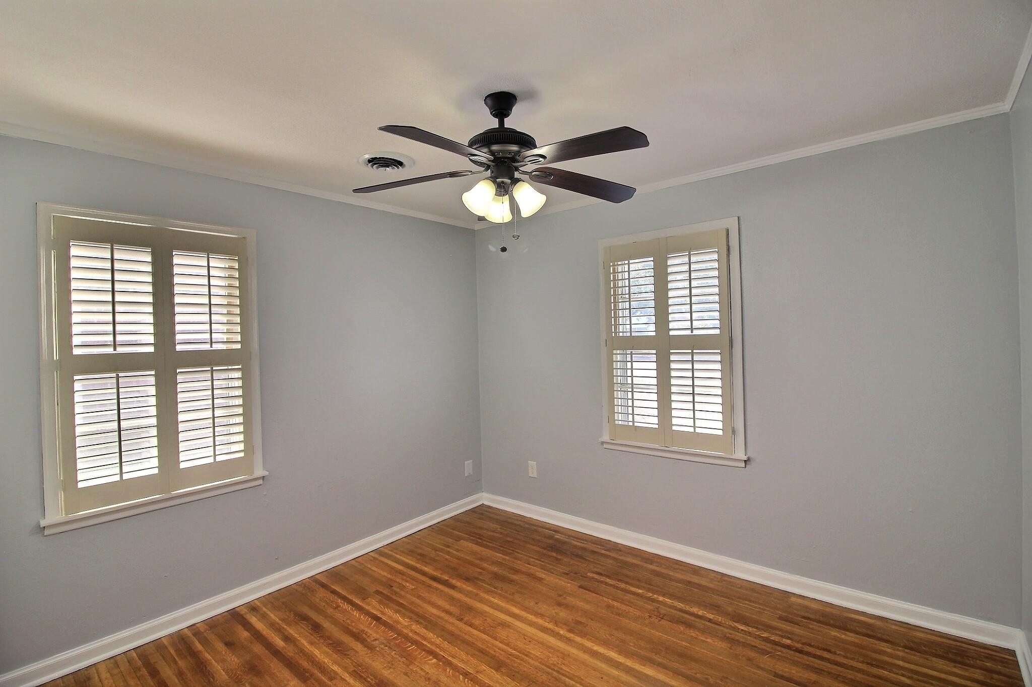 4528 Quince Road Memphis, TN 38117 - Photo 10 of 27 a view of an empty room with a window and wooden floor