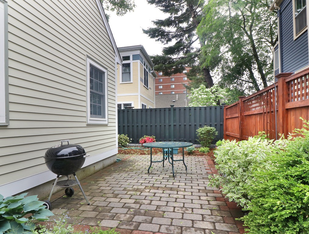 35 Shea Road Cambridge, MA 02140 - Photo 11 of 12 a view of a chairs and table in the back yard of the house