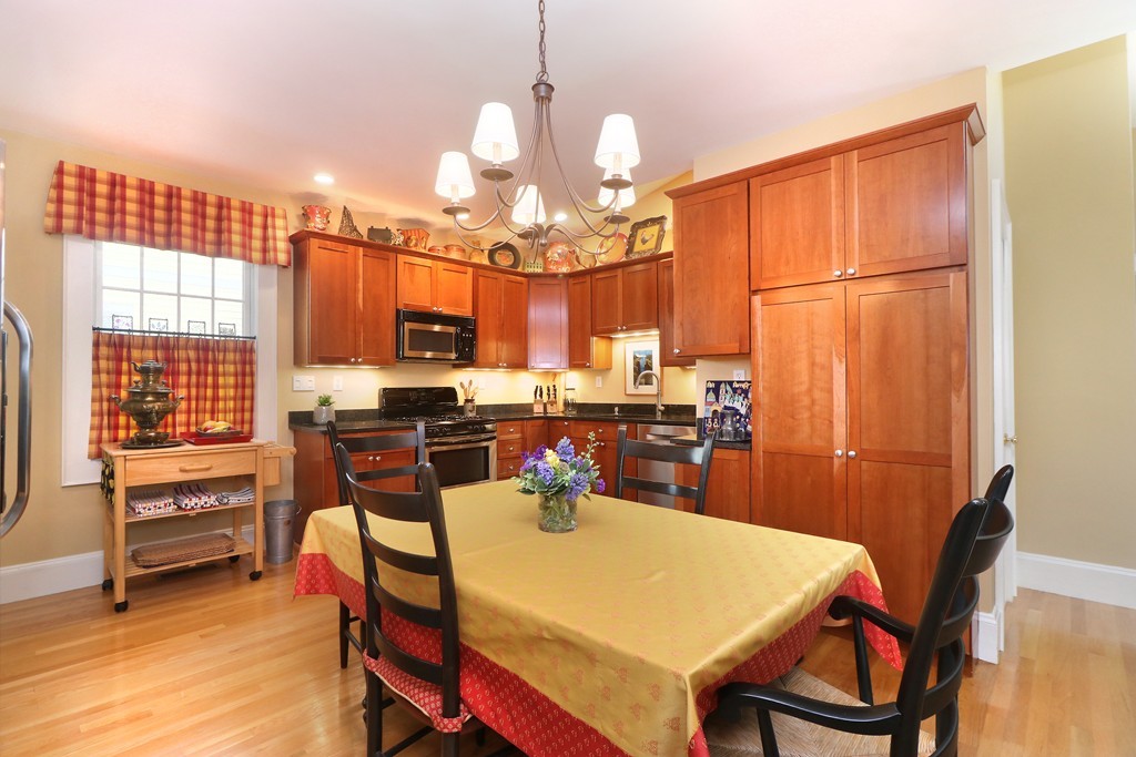 35 Shea Road Cambridge, MA 02140 - Photo 3 of 12 a kitchen with sink refrigerator dining table and chairs