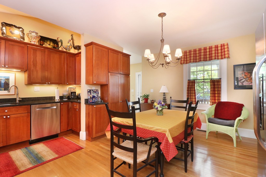 35 Shea Road Cambridge, MA 02140 - Photo 4 of 12 a outdoor kitchen with granite countertop a stove a sink a dining table and chairs with wooden floor