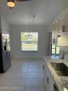 a kitchen with kitchen island granite countertop a sink stainless steel appliances cabinets and a counter top space