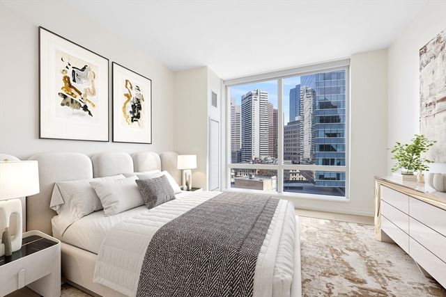 a bedroom with a large bed and a large window