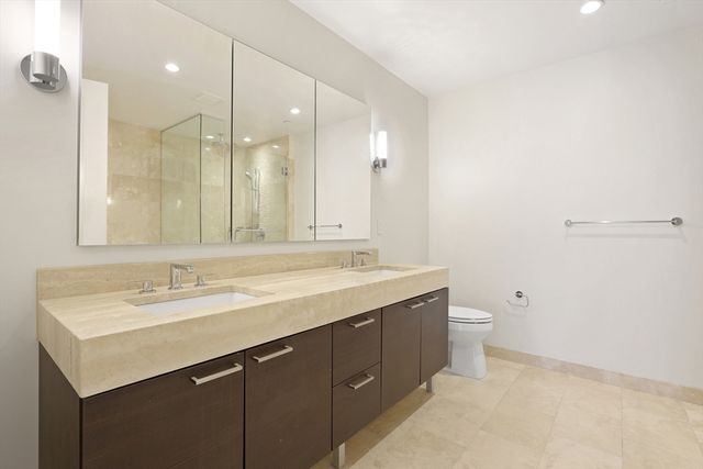 a bathroom with a sink a toilet and a mirror