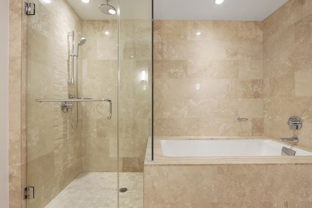 a bathroom with a shower and a bath tub