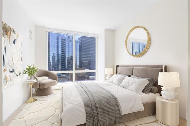 a bedroom with a large bed and a large window