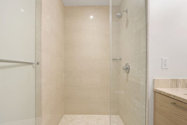 a bathroom with a shower and a sink