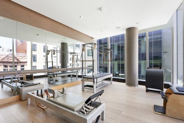 a kitchen with kitchen island granite countertop a stove and a living room view