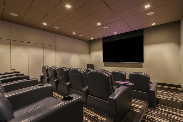 a media room with lots of chairs and a projector screen
