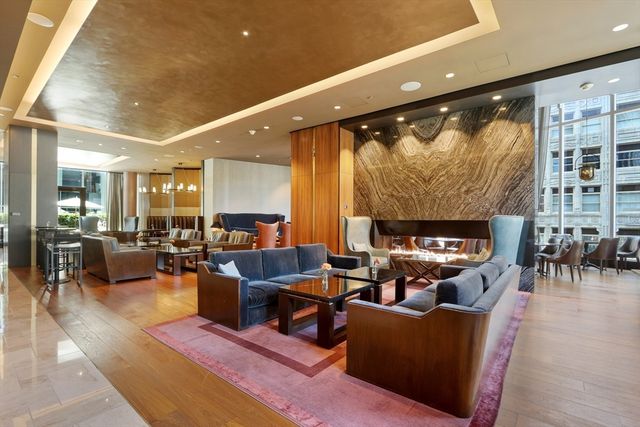 a living room with furniture kitchen view and a fireplace