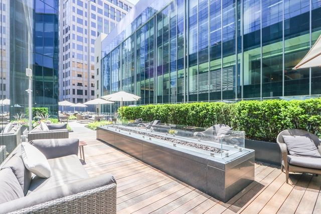 a view of a patio with couches and table and chairs and potted plants