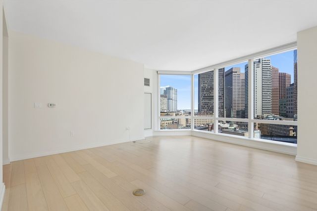 an empty room with large windows