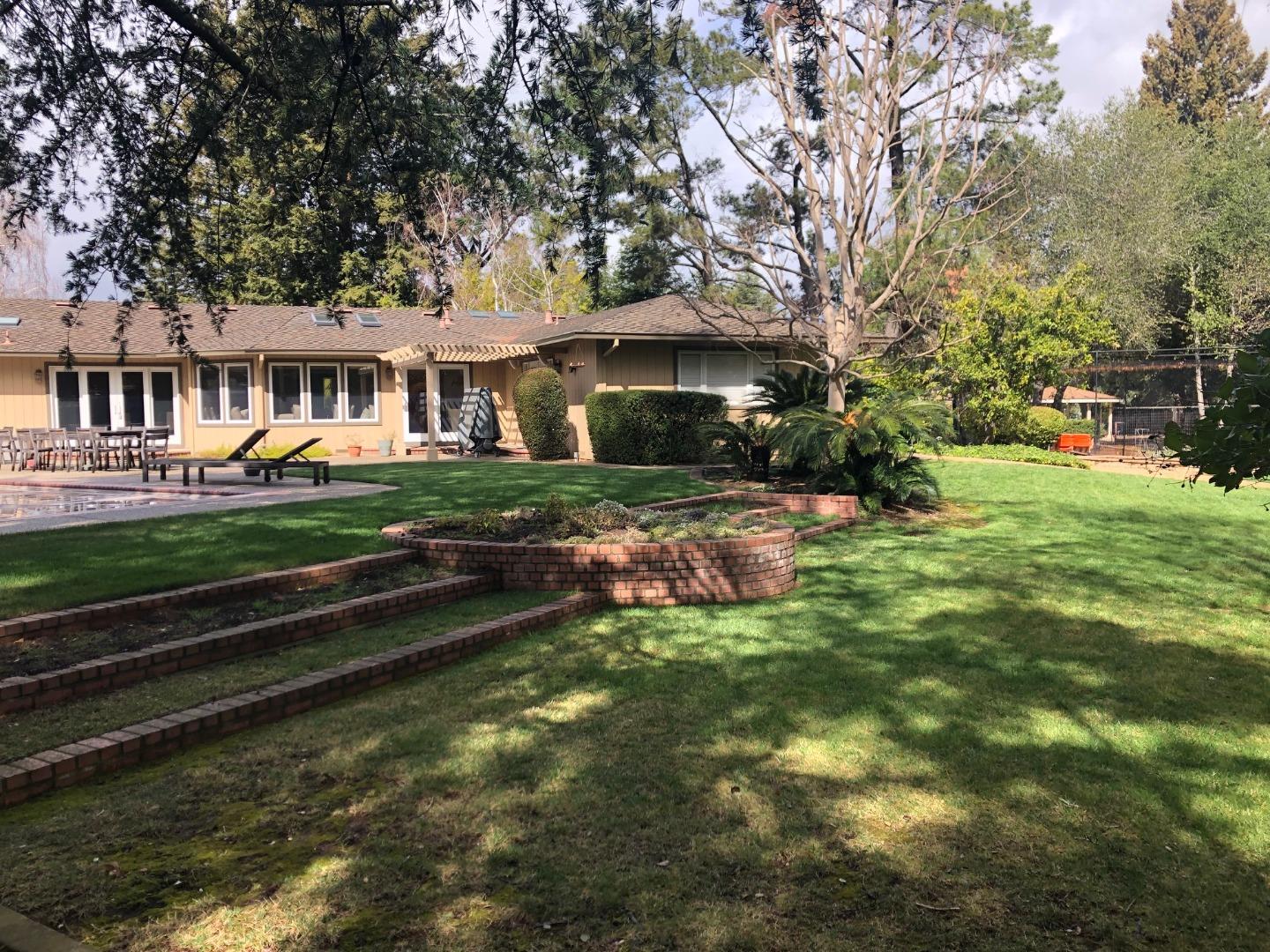 14072 Okanogan Drive Saratoga, CA 95070 - Photo 5 of 7 a front view of a house with a yard table and chairs