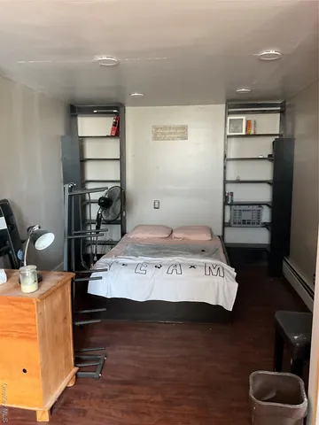 a view of a room with furniture and wooden floor